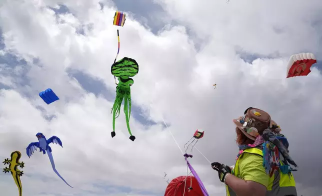 South African kite maker Mari Ware-Lane flies kites at the Cape Town International Kite Festival in Cape Town, South Africa, Sunday, Oct. 27, 2024. (AP Photo/Nardus Engelbrecht)