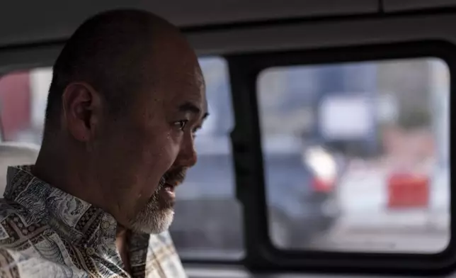 A teardrop rolls down the cheek of Kenneth Barthel, who was adopted from South Korea at the age of six, as he sits in a minivan in Busan, South Korea, Friday, May 17, 2024, after spending the day trying to uncover the details of his early life and find his birth family. (AP Photo/Jae C. Hong)