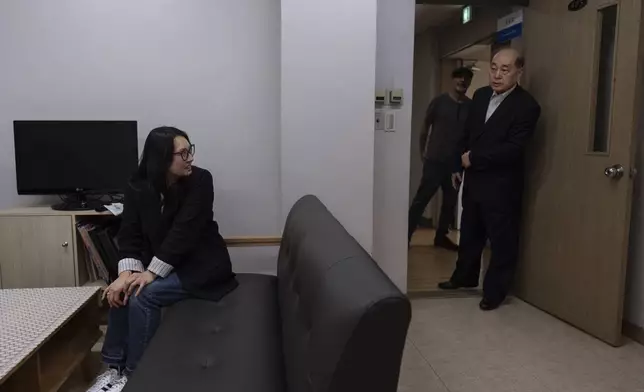 Nicole Motta, left, turns to see her birth father, Jang Dae-chang, as he enters the room at the Eastern Social Welfare Society in Seoul, South Korea, Friday, May 31, 2024, as they're reunited for the first time since she was adopted in 1985 by a family in Alabama. (AP Photo/Jae C. Hong)