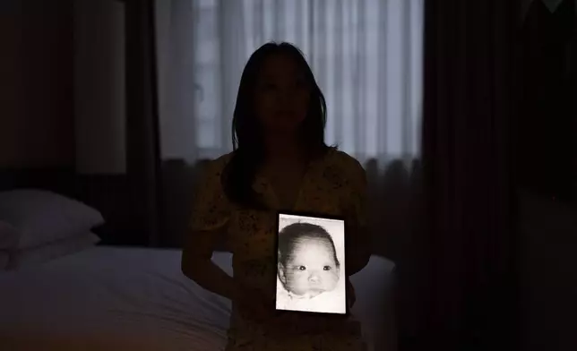 Maja Andersen sits for a photo in her hotel room, holding a tablet displaying her baby photo taken before her adoption to Denmark, as she visits Seoul, South Korea to search for her birth family, Monday, May 20, 2024. Andersen is among thousands of Korean adoptees who have taken a pilgrimage to their motherland for an emotional, often frustrating, sometimes devastating search for their origin story. (AP Photo/Jae C. Hong)