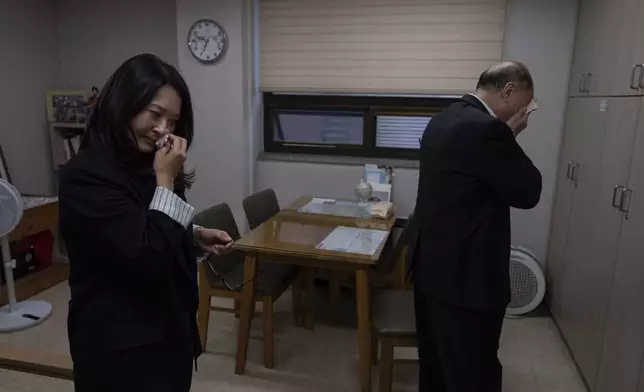 Adoptee Nicole Motta, left, and her birth father, Jang Dae-chang, wipe tears after an emotional reunion at the Eastern Social Welfare Society in Seoul, Friday, May 31, 2024. The moment they hugged, Motta, adopted to the United States in 1985, didn't need DNA test results, she knew she'd come from this man. "I am a sinner for not finding you," he said. "I think I have your nose," Motta said softly. They both sobbed. (AP Photo/Jae C. Hong)