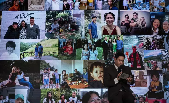 Photos of adoptees participating at the Overseas Korean Adoptees Gathering are displayed on a large screen during the conference in Seoul Tuesday, May 21, 2024. (AP Photo/Jae C. Hong)