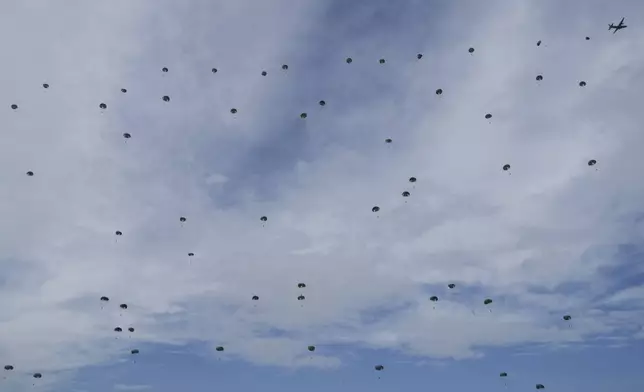 South Korean special army soldiers parachute down from a plane during the media day for the 76th anniversary of Armed Forces Day at Seoul air base in Seongnam, South Korea, Wednesday, Sept. 25, 2024. (AP Photo/Ahn Young-joon)