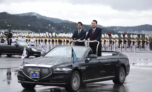 South Korean President Yoon Suk Yeol, right, inspects South Korean troops during a celebration to mark the 76th anniversary of Korea Armed Forces Day in Seongnam, South Korea Tuesday, Oct. 1, 2024. (Kim Hong-Ji/Pool Photo via AP)