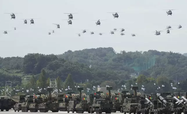 South Korean military helicopters fly over armored vehicles during the media day for the 76th anniversary of Armed Forces Day at Seoul air base in Seongnam, South Korea, Wednesday, Sept. 25, 2024. (AP Photo/Ahn Young-joon)