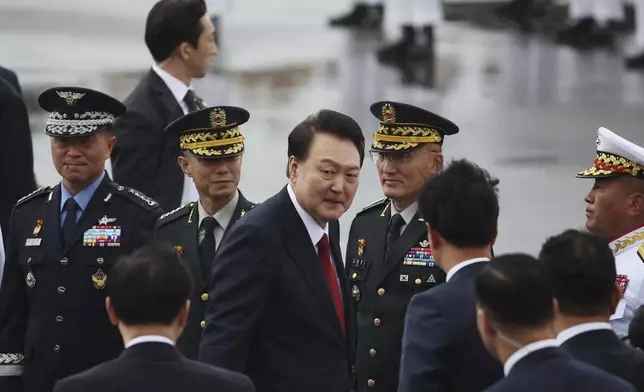 South Korean President Yoon Suk Yeol, center, arrives for a celebration to mark the 76th anniversary of Korea Armed Forces Day in Seongnam, South Korea Tuesday, Oct. 1, 2024. (Kim Hong-Ji/Pool Photo via AP)