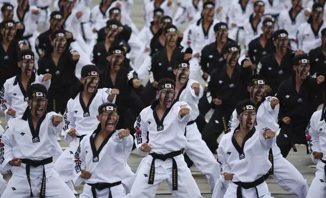 Members of the Special Warfare Command give a demonstration of their skills in the traditional Korean martial art of taekwondo during a celebration to mark 76th anniversary of Korea Armed Forces Day, in Seongnam, South Korea, Tuesday, Oct.1, 2024. (Kim Hong-Ji/Pool Photo via AP)