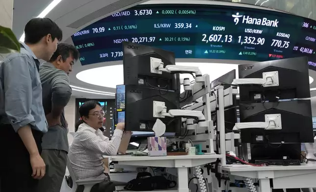 Currency traders work at the foreign exchange dealing room of the KEB Hana Bank headquarters in Seoul, South Korea, Monday, Oct. 14, 2024. (AP Photo/Ahn Young-joon)