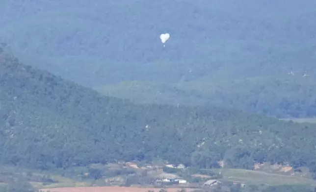 North Korean balloons are seen from the Unification Observation Post in Paju, South Korea, near the border with North Korea, Friday, Oct. 4, 2024. (AP Photo/Lee Jin-man)