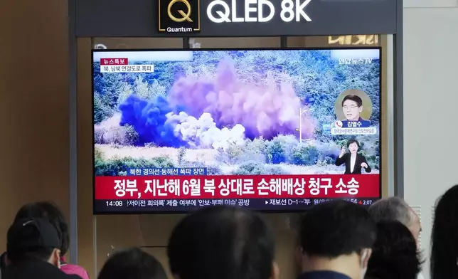 A TV screen reports North Korea has blown up parts of northern side of inter-Korean roads during a news program at Seoul Railway Station in Seoul, South Korea, Tuesday, Oct. 15, 2024. (AP Photo/Ahn Young-joon)