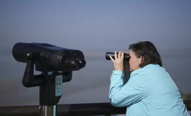 A visitor looks at the North Korean side from the unification observatory in Paju, South Korea, Thursday, Oct. 31, 2024. (AP Photo/Lee Jin-man)