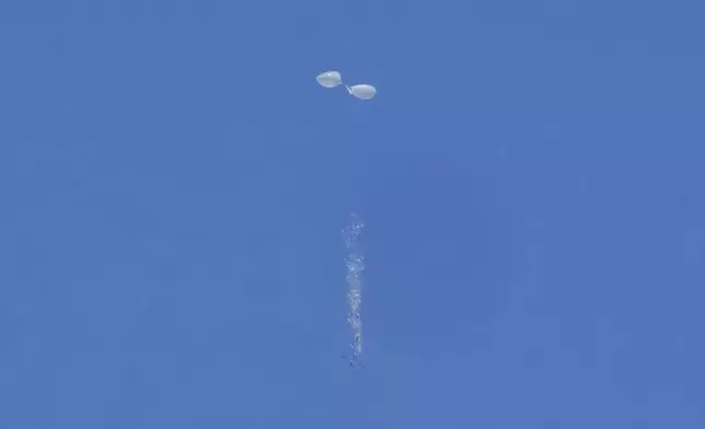 What local media reports "trash" fall from balloons flying over Seoul, South Korea, Friday, Oct. 4, 2024, as they are also reportedly sent from North Korea. (AP Photo/Ahn Young-joon)