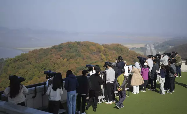 Visitors look at the North Korean side from the unification observatory in Paju, South Korea, Thursday, Oct. 31, 2024. (AP Photo/Lee Jin-man)