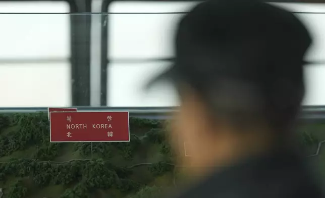 A visitor looks at a map of two Koreas border area at the unification observatory in Paju, South Korea, Thursday, Oct. 31, 2024. (AP Photo/Lee Jin-man)