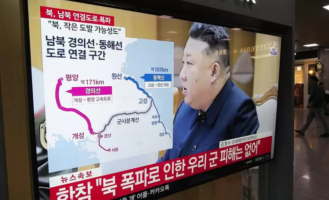 A TV screen reports North Korea has blown up parts of northern side of inter-Korean roads during a news program at Seoul Railway Station in Seoul, South Korea, Tuesday, Oct. 15, 2024. The sign on the screen reads, "North-South Gyeongui and Donghae roads line connection section." (AP Photo/Ahn Young-joon)