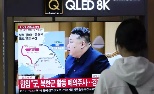 A TV screen reports North Korea has blown up parts of northern side of inter-Korean roads during a news program at Seoul Railway Station in Seoul, South Korea, Tuesday, Oct. 15, 2024. The sign on the screen reads, "North-South Gyeongui and Donghae roads line connection section." (AP Photo/Ahn Young-joon)