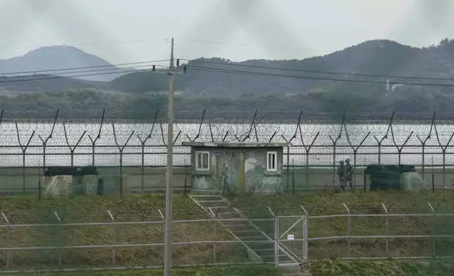 South Korean army soldiers patrol along the barbed-wire fence in Paju, South Korea, near the border with North Korea, Monday, Oct. 14, 2024. (AP Photo/Ahn Young-joon)