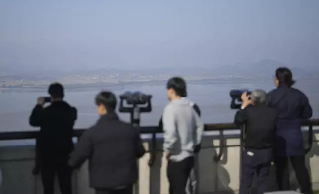 Visitors look at the North Korean side from the unification observatory in Paju, South Korea, Thursday, Oct. 31, 2024. (AP Photo/Lee Jin-man)