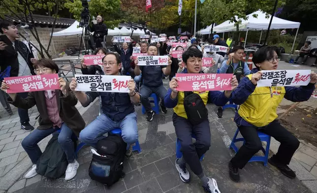 South Korean protesters stage a rally against flying of anti-North Korean propaganda leaflets into North Korea in Seoul, South Korea, Saturday, Oct. 19, 2024. The banners read, "Warmongering President Yoon Suk Yeol to step down." (AP Photo/Ahn Young-joon)