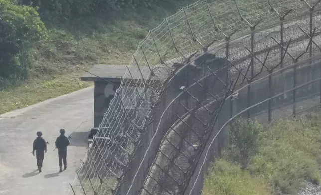 South Korean army soldiers patrol along the barbed-wire fence in Paju, South Korea, near the border with North Korea, Thursday, Oct. 10, 2024. (AP Photo/Ahn Young-joon)