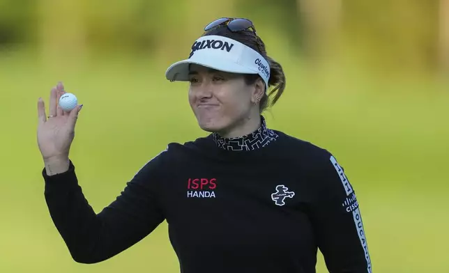 Hannah Green of Australia celebrates on the 18th hole after winning the LPGA Ladies Championship golf tournament at the Seowon Valley Country Club in Paju, South Korea, Sunday, Oct. 20, 2024. (AP Photo/Lee Jin-man)