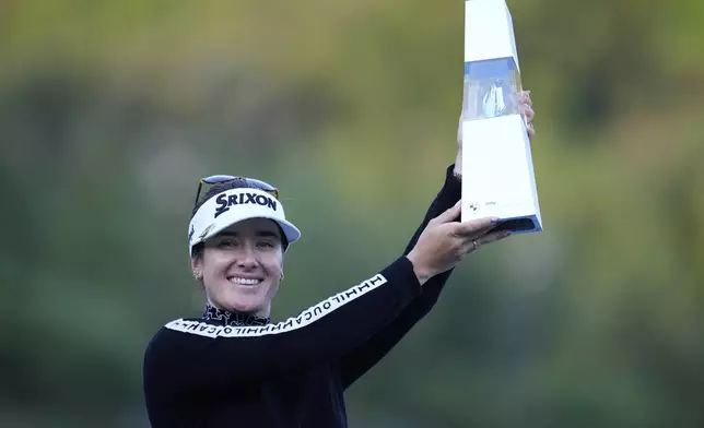 Hannah Green of Australia holds the winning trophy during the awards ceremony after winning the LPGA Ladies Championship golf tournament at the Seowon Valley Country Club in Paju, South Korea, Sunday, Oct. 20, 2024. (AP Photo/Lee Jin-man)