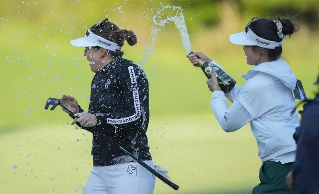 Hannah Green of Australia , left, celebrates after winning the LPGA Ladies Championship golf tournament at the Seowon Valley Country Club in Paju, South Korea, Sunday, Oct. 20, 2024. (AP Photo/Lee Jin-man)