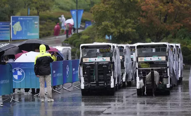 Players' golf carts are parked in front of the club house as the rain has suspended play during the second round of the LPGA Ladies Championship golf tournament at the Seowon Valley Country Club in Paju, South Korea, Friday, Oct. 18, 2024. (AP Photo/Lee Jin-man)