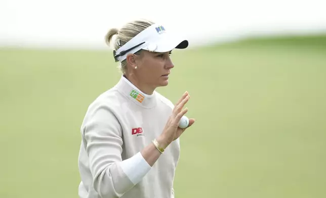 Ryann O'Toole of the United States acknowledges the gallery on the 5th green during the third round of the LPGA Ladies Championship golf tournament at the Seowon Valley Country Club in Paju, South Korea, Saturday, Oct. 19, 2024. (AP Photo/Lee Jin-man)