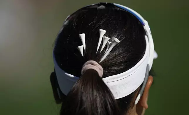 Chanettee Wannasaen of Thailand has tees in her hair on the 3rd green during the final round of the LPGA Ladies Championship golf tournament at the Seowon Valley Country Club in Paju, South Korea, Sunday, Oct. 20, 2024. (AP Photo/Lee Jin-man)