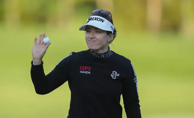 Hannah Green of Australia celebrates on the 18th hole after winning the LPGA Ladies Championship golf tournament at the Seowon Valley Country Club in Paju, South Korea, Sunday, Oct. 20, 2024. (AP Photo/Lee Jin-man)