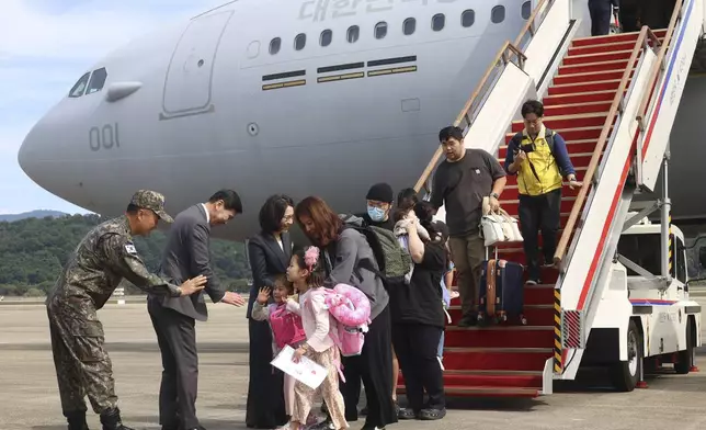 South Korean nationals and their family members arrive after being evacuated from Lebanon with a South Korea's military aircraft at the Seoul airport in Seongnam, South Korea, Saturday, Oct. 5, 2024. (Korea Pool/Yonhap via AP)