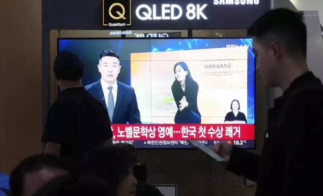 A TV screen shows a file image of the winner of the 2024 Nobel Prize in Literature, South Korean writer Han Kang, during a news program at Seoul Railway Station in Seoul, South Korea, Thursday, Oct. 10, 2024. (AP Photo/Ahn Young-joon)