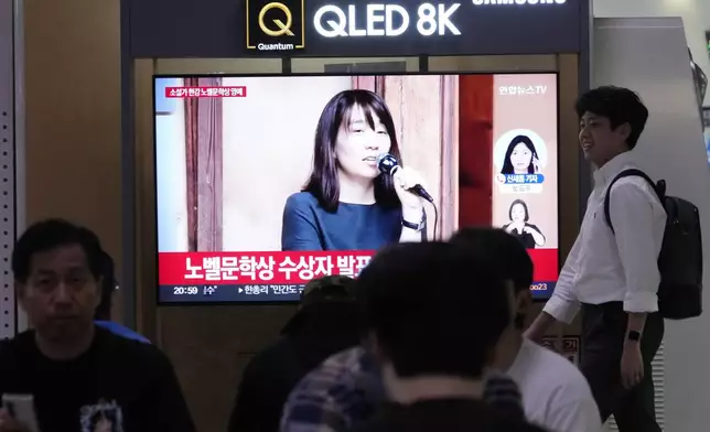 A TV screen shows a file image of the winner of the 2024 Nobel Prize in Literature, South Korean writer Han Kang, during a news program at Seoul Railway Station in Seoul, South Korea, Thursday, Oct. 10, 2024. (AP Photo/Ahn Young-joon)