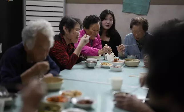 Leader Park Jeom-sun, 82-year-old, center, and other members of Suni and the Seven Princesses eat lunch before their training at senior community center in Chilgok, South Korea, Thursday, Oct. 3, 2024. (AP Photo/Lee Jin-man)