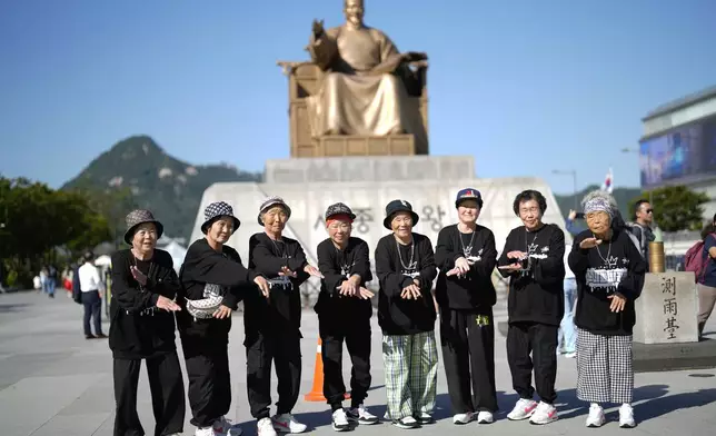 Members of Suni and the Seven Princesses pose for a photo at Gwanghwamun square in Seoul, South Korea, Friday, Oct. 4, 2024. (AP Photo/Lee Jin-man)