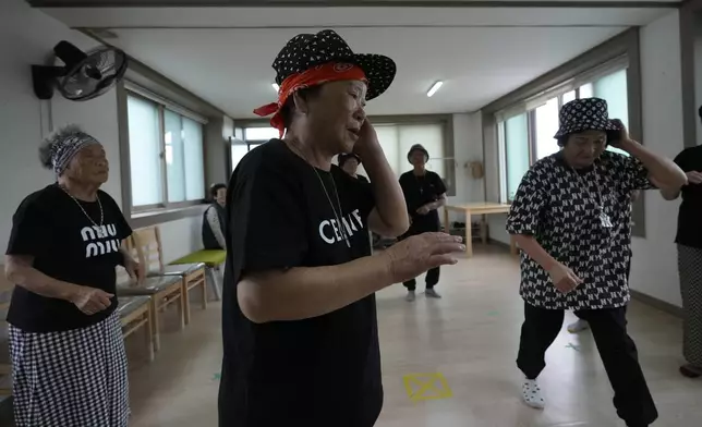 Members of Suni and the Seven Princesses exercise at senior community center in Chilgok, South Korea, Thursday, Oct. 3, 2024. (AP Photo/Lee Jin-man)