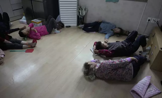 Members of Suni and the Seven Princesses rest after their lunch at senior community center in Chilgok, South Korea, Thursday, Oct. 3, 2024. (AP Photo/Lee Jin-man)