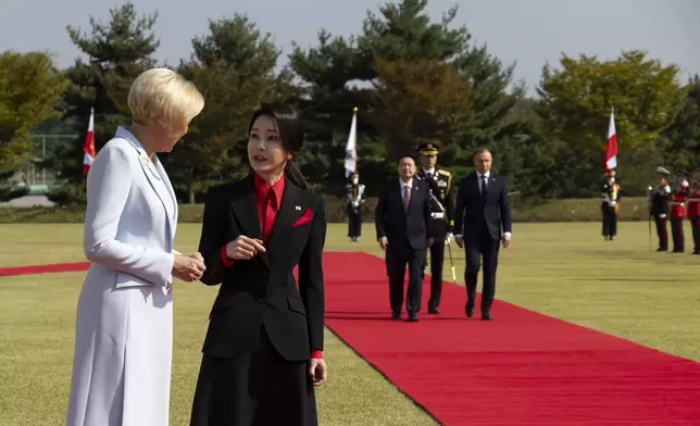 South Korean first lady Kim Keon-Hee, second from left, talks with Polish first lady Agata Kornhauser-Duda, left, as South Korea's President Yoon Suk Yeol, third from left, and Poland's President Andrzej Duda, right, walk with honor guards during a welcoming ceremony at the Presidential Office in Seoul, South Korea, Thursday, Oct. 24, 2024. (Jeon Heon-Kyun/Pool Photo via AP)