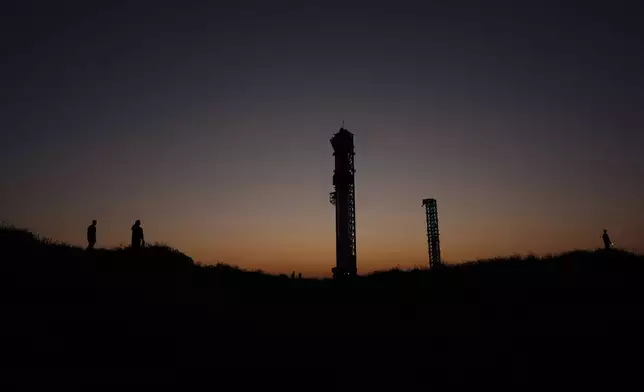 The sun sets behind SpaceX's mega rocket Starship, Saturday, Oct. 12, 2024, in Boca Chica, Texas. (AP Photo/Eric Gay)