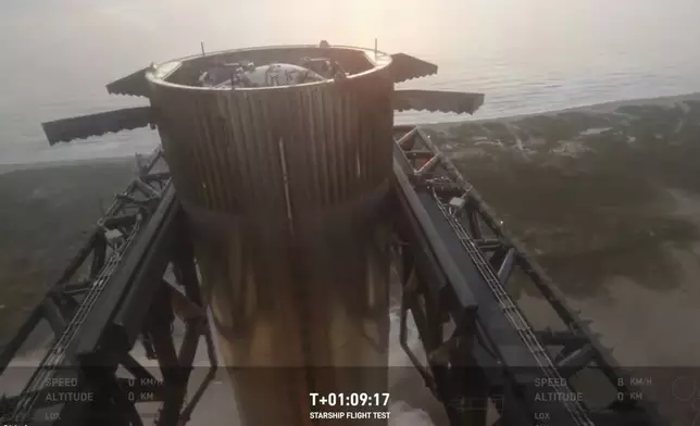 This image provided by SpaceX shows SpaceX's mega rocket booster returning to the launch pad to be captured during a test flight Sunday, Oct. 13, 2024, in Boca Chica, Texas. (SpaceX via AP)