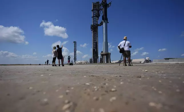 Onlookers watch as SpaceX's Starship rocket is prepared for a test launch in Boca Chica, Texas, Saturday, Oct. 12, 2024. (AP Photo/Eric Gay)