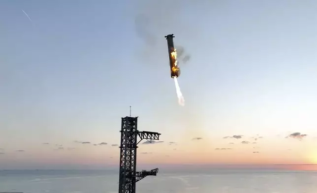 This image provided by SpaceX shows SpaceX's mega rocket booster returning to the launch pad to be captured during a test flight Sunday, Oct. 13, 2024, in Boca Chica, Texas. (SpaceX via AP)