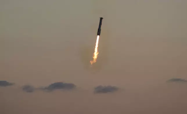 SpaceX's mega rocket booster returns to the launch pad to be captured during a test flight Sunday, Oct. 13, 2024, in Boca Chica,, Texas. (AP Photo/Eric Gay)