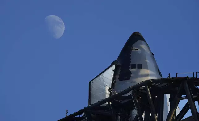 The moon rises over SpaceX's mega rocket Starship as it is prepares for a test launch Saturday, Oct. 12, 2024, in Boca Chica, Texas. (AP Photo/Eric Gay)