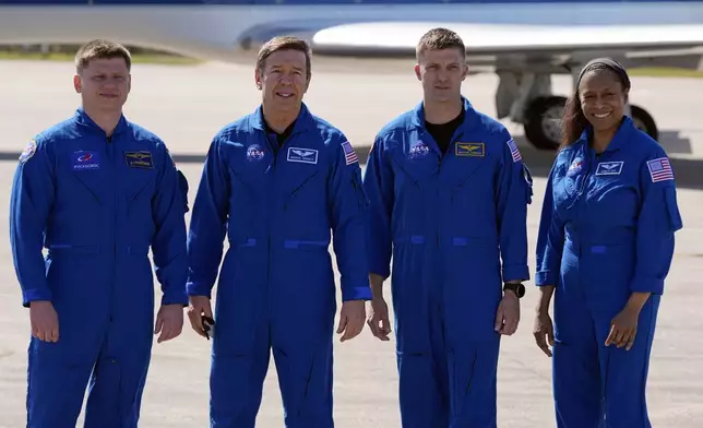 The SpaceX crew of the Dragon spacecraft, from left, cosmonaut Alexander Grebenkin, pilot Michael Barratt, commander Matthew Dominick and mission specialist Jeanette Epps gather for a photo after arriving at the Kennedy Space Center in Cape Canaveral, Fla., Sunday, Feb. 25, 2024. (AP Photo/John Raoux, File)