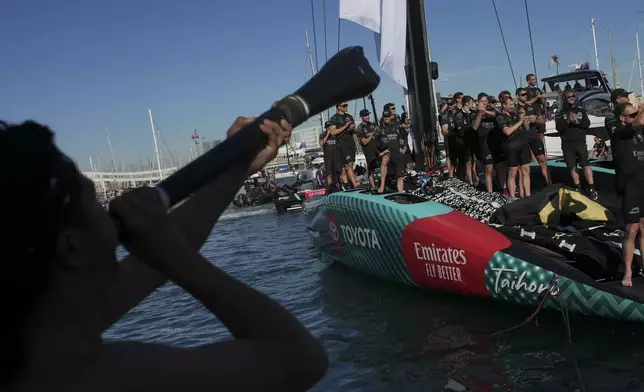 Emirates Team New Zealand crew celebrates as they won the Louis Vuitton 37th America's Cup in Barcelona, Spain, on Saturday, Oct. 19, 2024. (AP Photo/Emilio Morenatti)