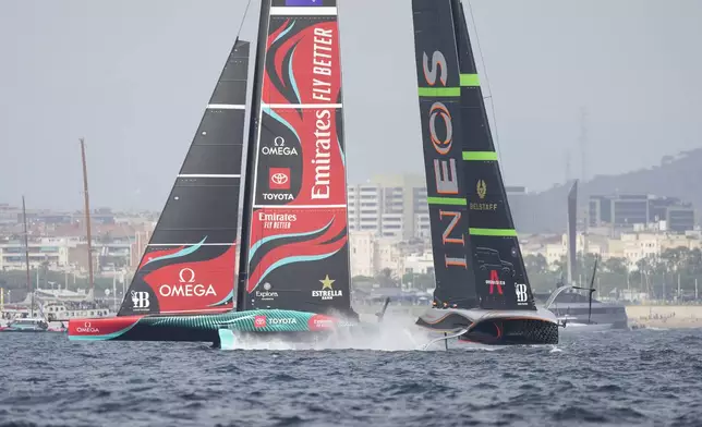 Ineos Britannia and Emirates Team New Zealand race during the Louis Vuitton 37th America's Cup Day 2 race in Barcelona, Spain, Sunday, Oct. 13, 2024. (AP Photo/Bernat Armangue)