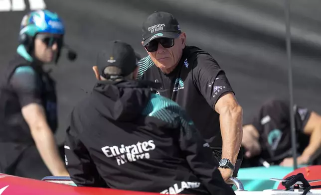 Emirates Team New Zealand CEO Grant Dalton talks to a crew member crew ahead of the Louis Vuitton 37th America's Cup Day 6 race 9 in Barcelona, Spain, Saturday, Oct.19, 2024. (AP Photo/Bernat Armangue)