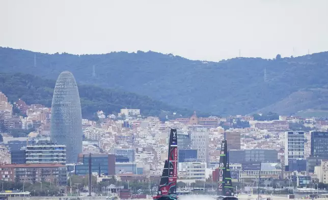 Ineos Britannia and Emirates Team New Zealand race during Louis Vuitton 37th America's Cup Day 5 race 8 in Barcelona, Spain, Friday, Oct. 18, 2024. (AP Photo/Bernat Armangue)